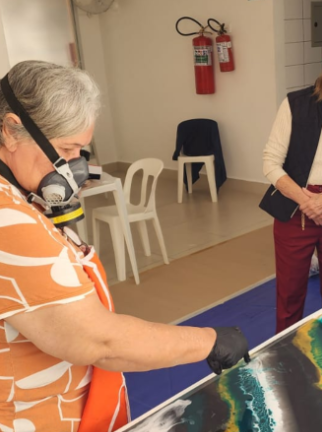 Dirce orientando alunas durante aula prática de resina epóxi